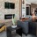Spacious well lit clubhouse with a firepit and tv and plenty of seating. 