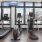 Spacious well lit fitness center with cardio equiptment and weight machines.