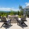 Beautiful fire pit with chairs situated on a deck that over looks the scenery.