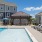 Sparkling blue pool with a sundeck and plenty of lounge chairs.