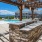 Sparkling blue pool with a sundeck and plenty of lounge chairs.