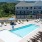 Sparkling blue pool with a sundeck and plenty of lounge chairs.