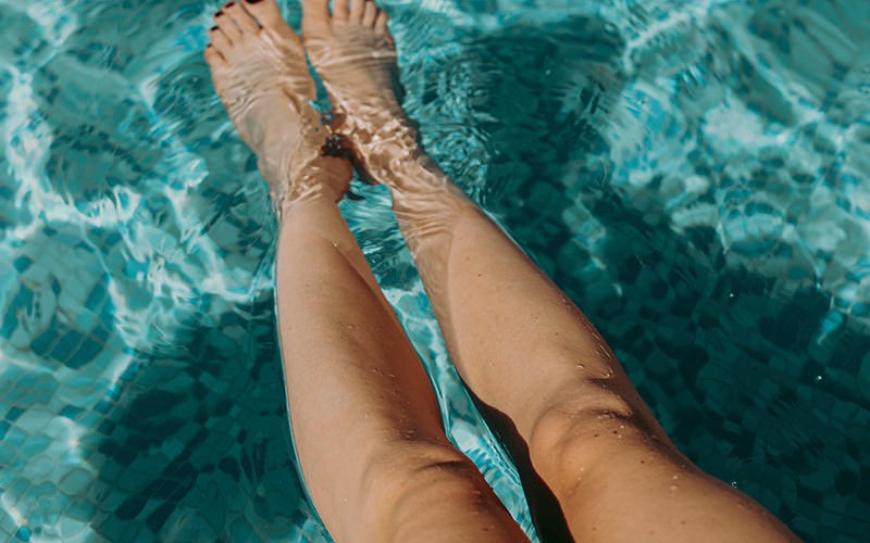woman with feet in pool